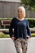 WT Cotton Rollup Sleeve Knit in navy with stylish side buttons and rollup sleeves, paired with patterned pants.