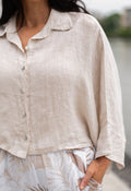 WT Cropped poncho in soft sand linen with button front detail and relaxed fit.