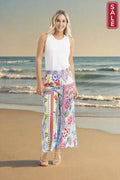 Model showcasing Digital Pants Oriental Floral on the beach, perfect for stylish summer outfits.