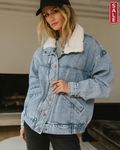 Stylish woman wearing Borg collar Denim Jacket with plush collar, slanted pockets, and edgy studs indoors.