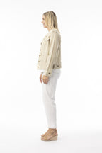 Side view of a woman wearing the Essentials Jacket sand with frayed trim and front bust pockets.