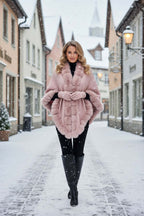 Model wearing the Camilla Shawl in a snowy street, showcasing its luxurious faux fur trim and elegant style.