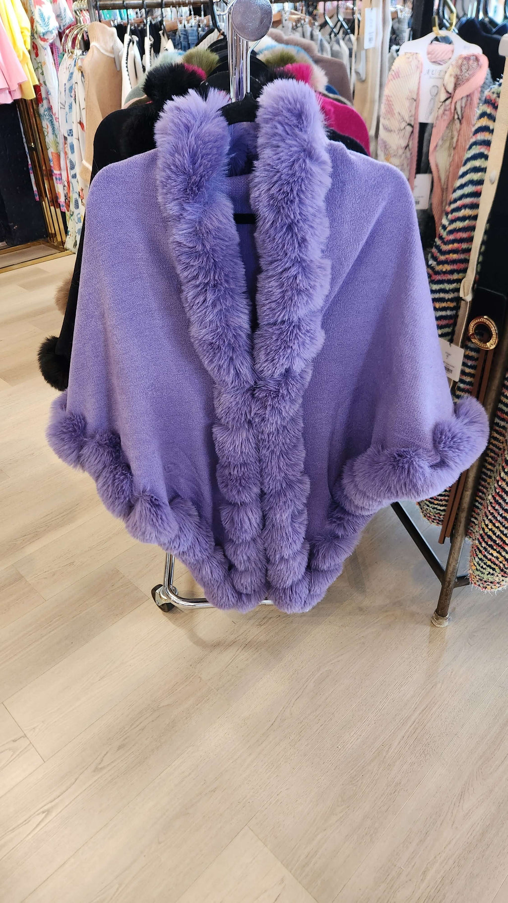 Camilla Shawl in soft purple with luxurious faux fur trim, perfect for elegant and cozy styling.