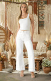 Model wearing Cream Wide Leg Jeans styled with a white top, showcasing a trendy bohemian interior.