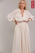 Ayana Maxi Dress - Ecru modeled by a woman, showcasing its dramatic sleeves and shirred waistband.
