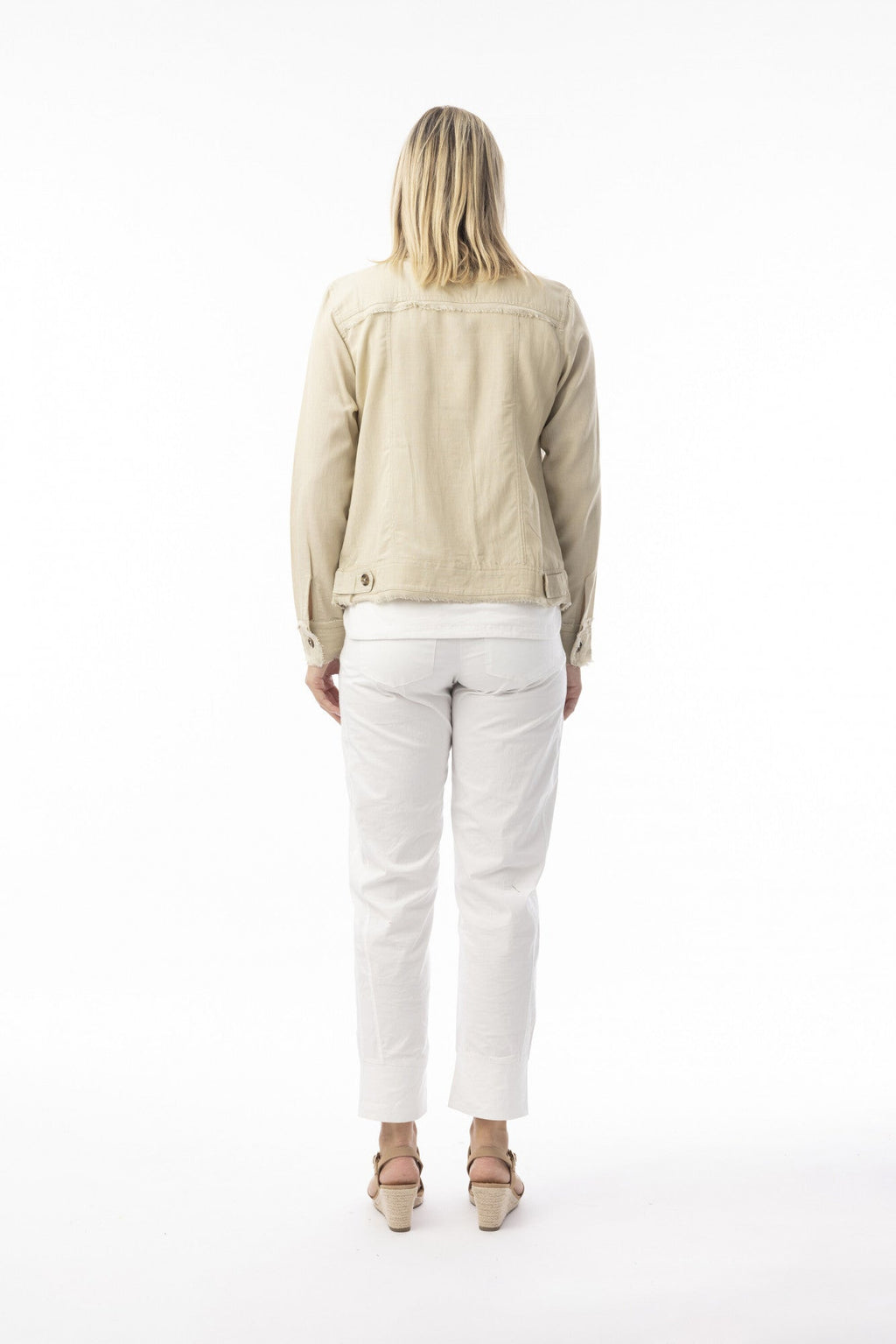 Essentials Jacket sand worn by a model from the back, showcasing its stylish frayed trim and casual elegance.