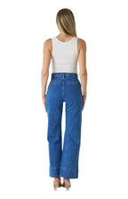 Back view of a model wearing WK 3085 Patch pocket jean with wide leg silhouette and high-rise waist.