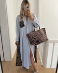 Woman wearing a Striped & Leopard Dress Shirt with a leopard print handbag, showcasing a stylish outfit.