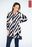 Model wearing WT Abstract Tunic featuring navy and beige stripes, covered buttons, and pockets.
