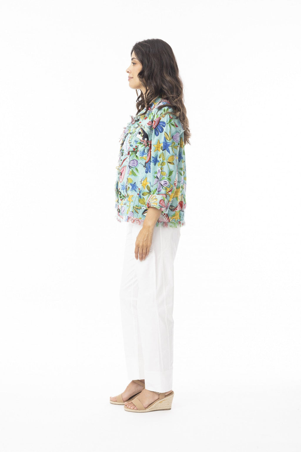 Side view of a model wearing the Sante Fe Jacket 2 with colorful floral design and fringe trim.