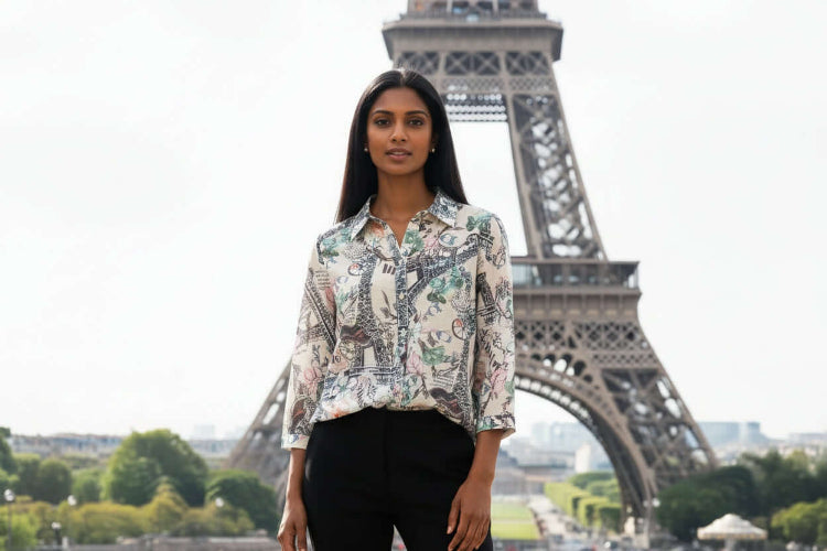 WT Suzy Eiffel tower Shirt model stands in front of the Eiffel Tower, showcasing its chic and stylish design.