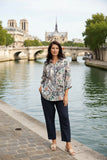 Woman wearing WT Suzy Eiffel tower Shirt by the river in Paris, showcasing effortless chic style.