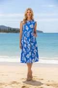 Comodoro Blue Pleated Waist Sleeveless Dress showcased on a model by the beach, exuding effortless summer elegance.