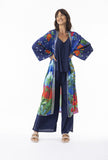 Model wearing Arabian Nights Wrap Long with colorful floral design, showcasing kimono sleeves and bohemian style.