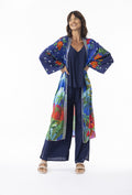 Model wearing Arabian Nights Wrap Long with colorful floral design, showcasing kimono sleeves and bohemian style.