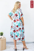 Back view of a woman wearing a Panel Dress Aqua leaves with floral patterns, perfect for a stylish summer look.