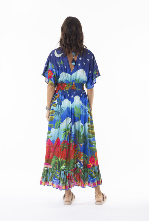 Woman wearing the Arabian Nights Dress Shirred Waist showing vibrant print and relaxed silhouette from the back.