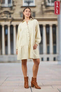 Model showcasing the Urban Dress Creme, a stylish denim dress with collar and button-up design.