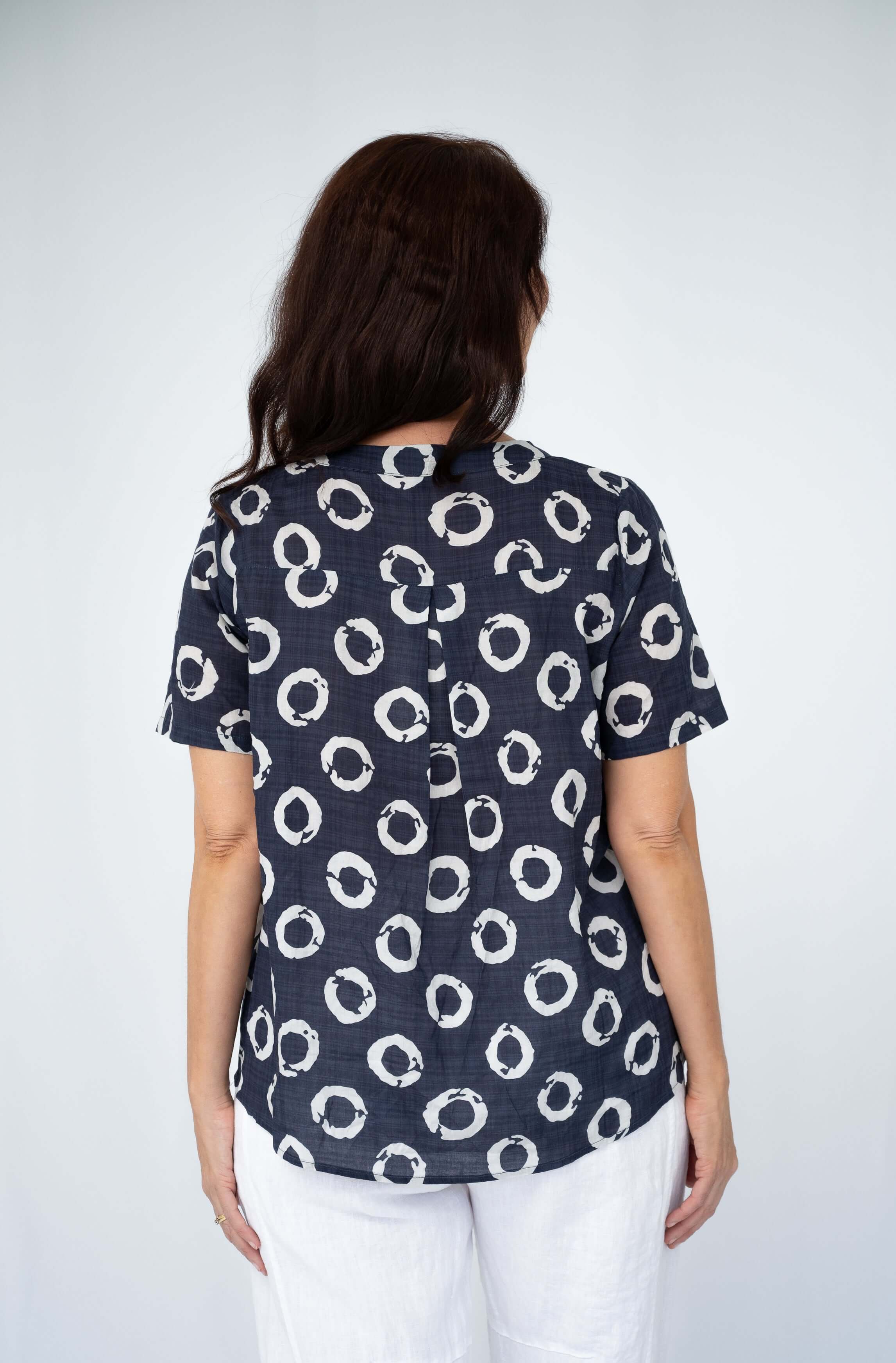Back view of the Vera Sequin pocket top showcasing its playful circle pattern and soft fabric.