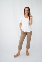 Model wearing WT Lace Trim Top with short sleeves and beige pants, showcasing elegant comfort and casual style.