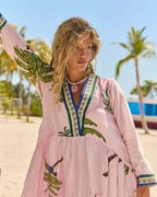 Model wearing the Penelope Maxi Amazon dress, showcasing vibrant Amazon print and relaxed silhouette in a tropical setting.