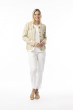 Model wearing the Essentials Jacket sand with stylish frayed trim and front pockets, perfect for summer layering.