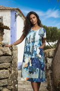 Model wearing the Tower Blue Shift Dress, showcasing stylish design and vibrant colors against a scenic backdrop.