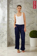 Woman wearing Verona Pant Riviera with a tank top, showcasing a stylish wide-leg design and elegant fabric.