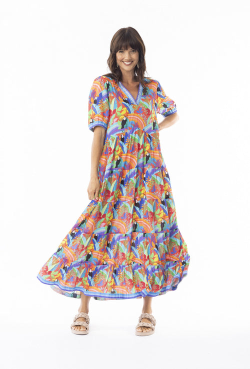 Model wearing the Bianca Maxi Dress with vibrant tropic print and v-neckline, perfect for summer occasions.