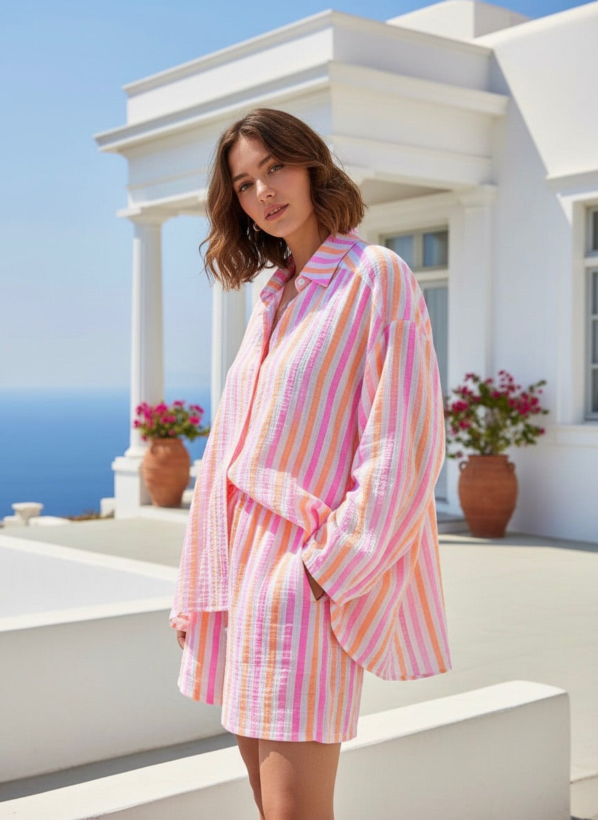 Model wearing a Candy striped shirt 945 with pink, white, and orange stripes, showcasing effortless style outdoors.