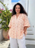 Cherry Shirt Tangerine displayed on a model, showcasing its elegant lace detailing and relaxed fit in a vibrant tangerine color.