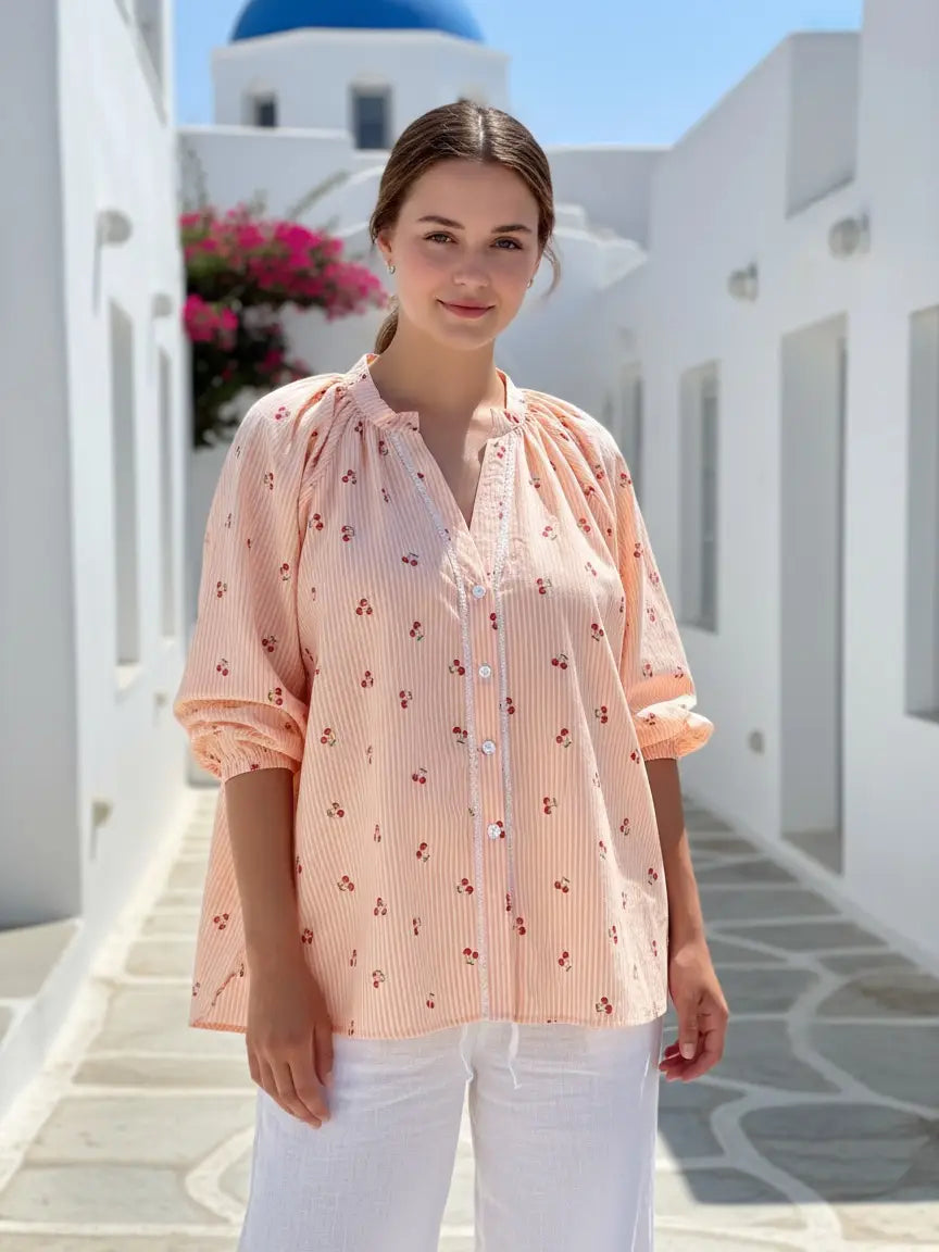 Cherry Shirt Tangerine worn by model outdoors, featuring a Nehru collar and 3/4 elasticated sleeves.