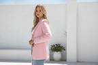 Model showcasing the Aurora Blazer in pink, exemplifying modern elegance and timeless tailoring.