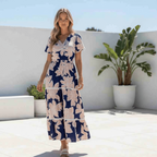 Model wearing the Collette Maxi Dress with magnolia print and ric rac trim on a sunny day.