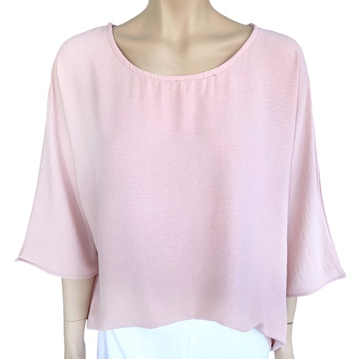 Eva Crew Neck top in soft pink color with round neckline and flowy sleeves on a mannequin.