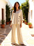 Gianna Wide Leg Pant modeled with a stylish top in a sunlit garden setting, showcasing comfort and elegance.
