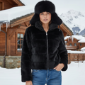 Paloma Faux Fur Jacket worn by a model, featuring a zip front and side pockets against a snowy backdrop.