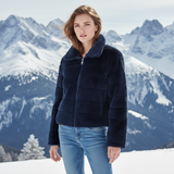 Paloma Faux Fur Jacket in navy perfect for winter, featuring a zip front and side pockets, set against snowy mountains.