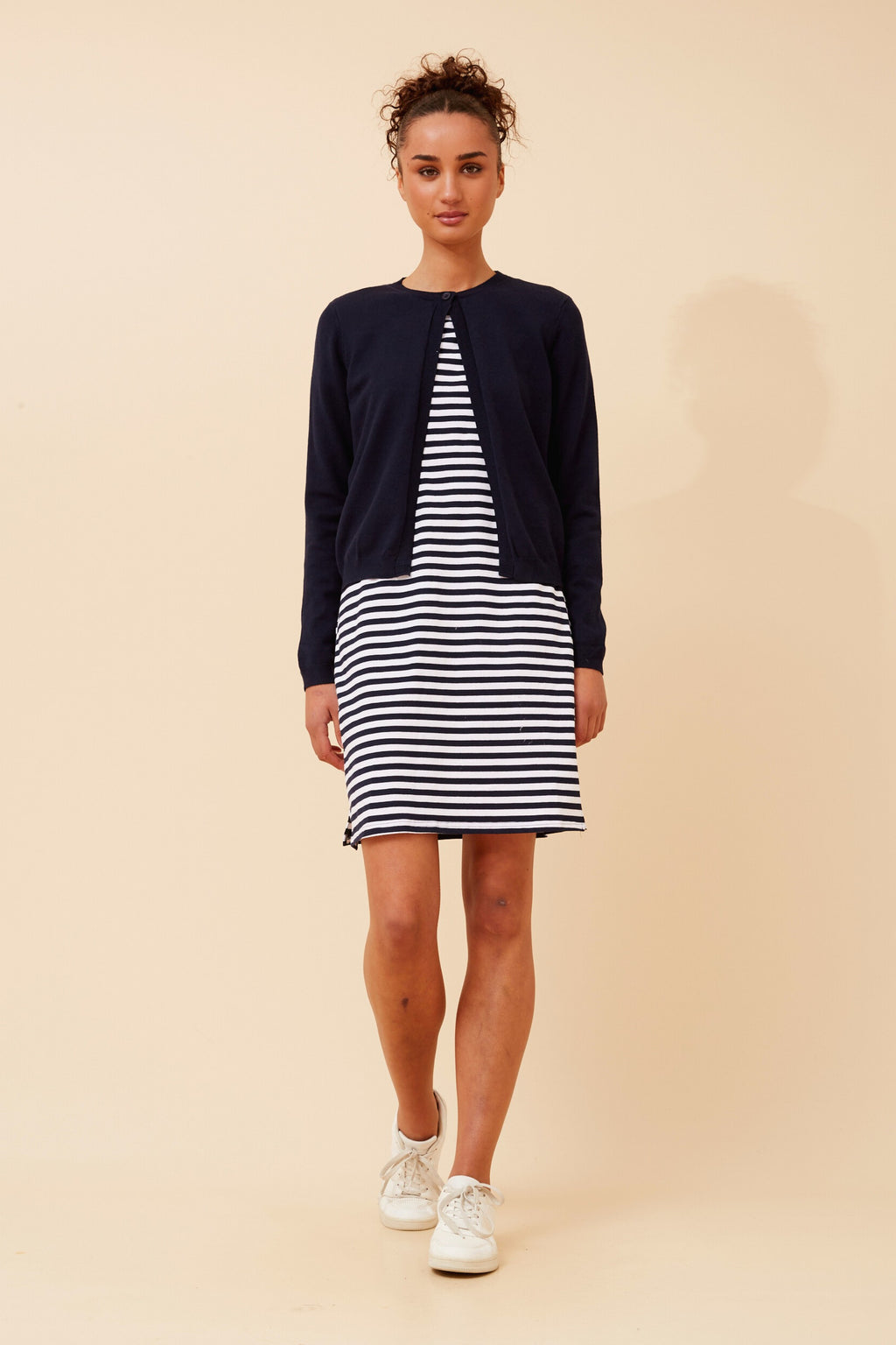 Model wearing Stripe T-shirt Dress with navy cardigan, showcasing a stylish and casual look.