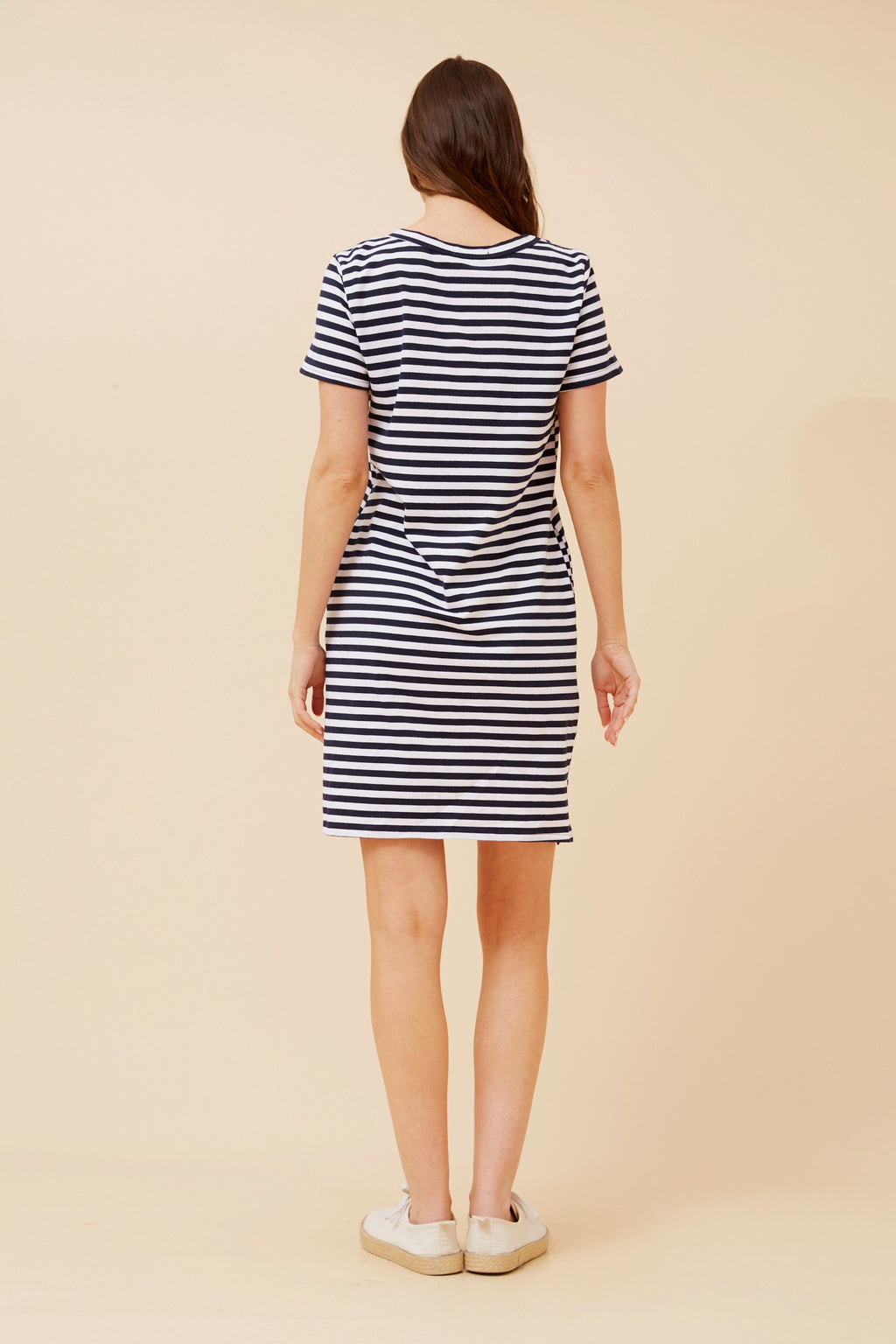 Back view of a woman wearing a Stripe T-shirt Dress in navy and white stripes, perfect for casual summer outings.