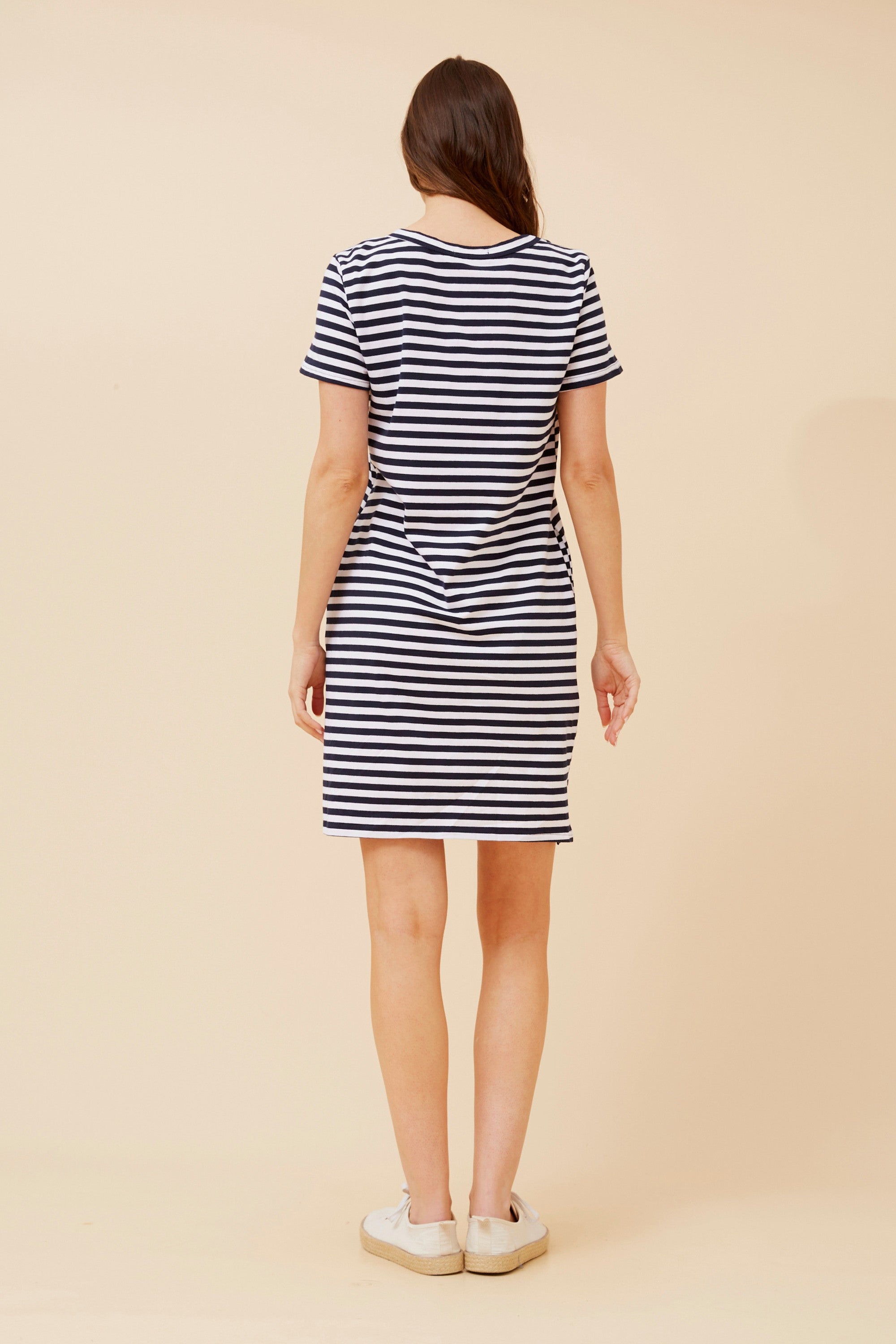 Back view of a woman wearing a Stripe T-shirt Dress with navy and white stripes.