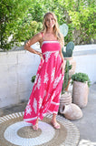 Maria Dress-pink model wearing a vibrant pink maxi dress in a sunny outdoor setting.