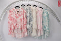 WL Gauri cotton top collection featuring pink and blue patterned short sleeve designs on hanging racks.