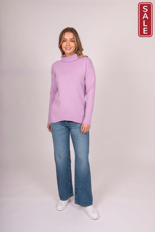 Model wearing the Bella Rollneck Lilac sweater with jeans, showcasing the stylish fine knit design.