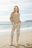 Model wearing Avalon Pants by Wednesday Lulu at the beach, showcasing textured elegance and relaxed style.