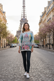 A model wearing the Cuba Knit top in front of the Eiffel Tower, showcasing a chic look in Paris.