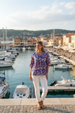 Model wearing Ibisa Tennesee Top by the marina, showcasing elegant style and comfort in a scenic harbor setting.