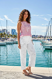 Model wearing Isha Linen Pants with a pink top by the waterfront for a chic summer look.