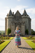 Woman in Selaron Dress V Neckline Maxi Layers standing in front of a castle on a sunny day.