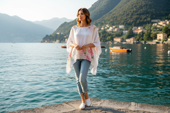 Model wearing the Dora Top by Wednesday Lulu, a floral print linen top, with a beautiful lake view.